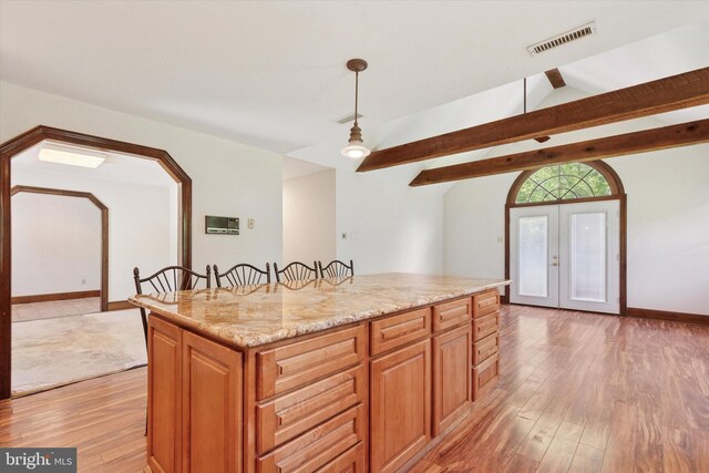 3789 Stump Rd, Doylestown, PA 18902 - kitchen featuring light wood-style floors, a center island, pendant lighting, french doors, and light stone countertops