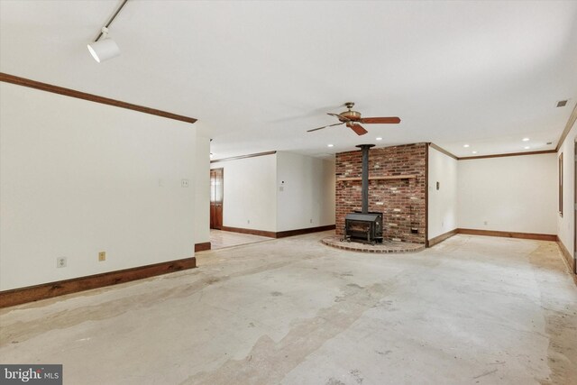3789 Stump Rd, Doylestown, PA 18902 - unfurnished living room featuring concrete floors, ornamental molding, baseboards, a wood stove, and a ceiling fan