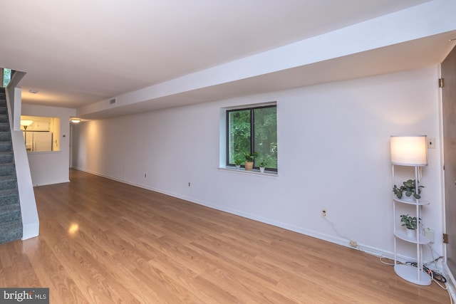 264 Summit House Unit 264, West Chester, PA 19382 - unfurnished living room featuring light wood finished floors, stairway, and baseboards