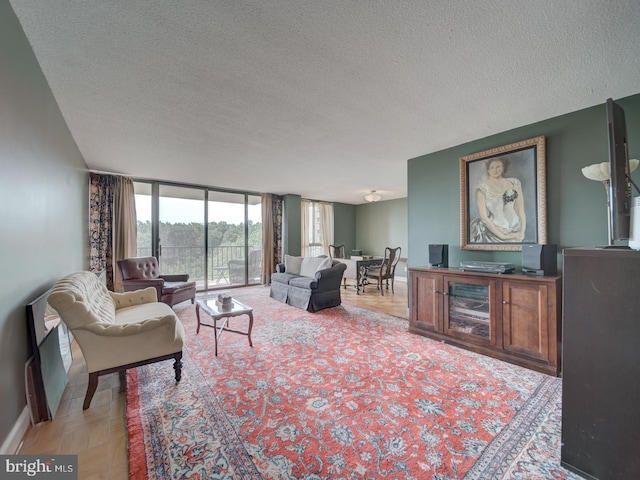6100 Westchester Park Dr Unit 804, College Park, MD 20740 - living area featuring a textured ceiling, a wall of windows, and baseboards