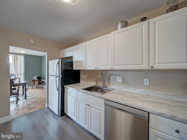 6100 Westchester Park Dr Unit 804, College Park, MD 20740 - kitchen with stainless steel appliances, a sink, white cabinetry, light countertops, and dark wood-style flooring