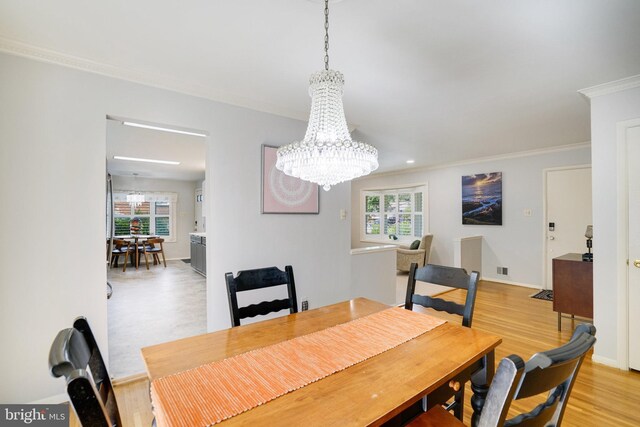 5101 Ampthill Dr, Alexandria, VA 22312 - dining space featuring a chandelier, healthy amount of natural light, light wood-style flooring, crown molding, and baseboards