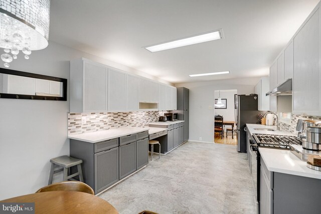 5101 Ampthill Dr, Alexandria, VA 22312 - kitchen with stainless steel appliances, gray cabinets, a sink, and backsplash
