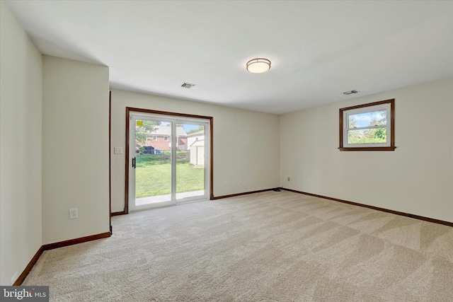 empty room with baseboards and light carpet