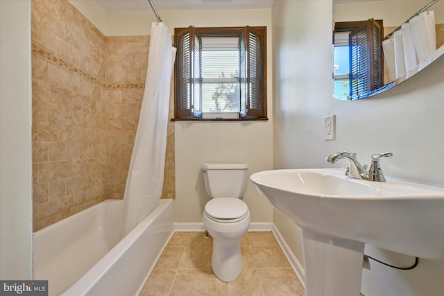 full bath with tile patterned flooring, toilet, baseboards, and shower / bathtub combination with curtain