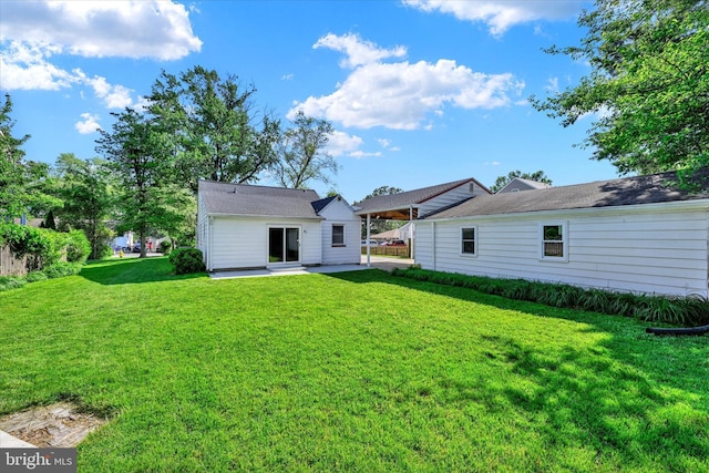 rear view of property with a patio area and a lawn