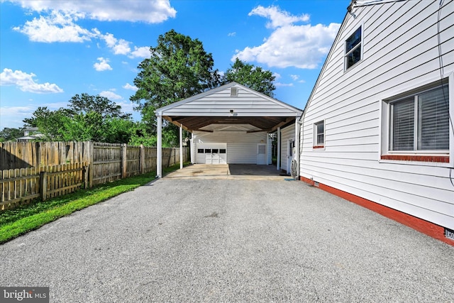 view of parking / parking lot with driveway and a garage