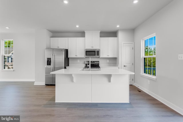 14 Chesapeake Ln Unit C, La Plata, MD 20646 - kitchen with stainless steel appliances, baseboards, a center island with sink, light countertops, and recessed lighting