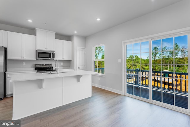 14 Chesapeake Ln Unit C, La Plata, MD 20646 - kitchen with stainless steel appliances, light wood finished floors, light countertops, an island with sink, and recessed lighting