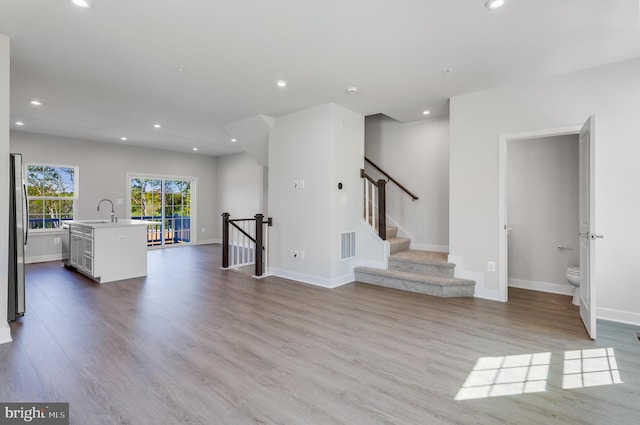 14 Chesapeake Ln Unit C, La Plata, MD 20646 - unfurnished living room with recessed lighting, wood finished floors, baseboards, and a sink