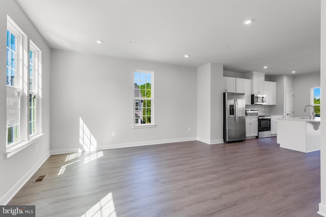 14 Chesapeake Ln Unit C, La Plata, MD 20646 - unfurnished living room with a sink, recessed lighting, baseboards, and dark wood finished floors