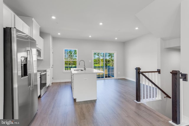 14 Chesapeake Ln Unit C, La Plata, MD 20646 - kitchen with appliances with stainless steel finishes, a center island with sink, dark wood-style flooring, white cabinets, and a sink
