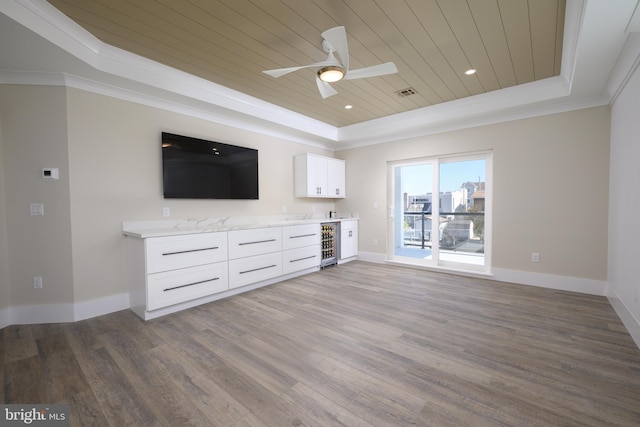 1426 Paul Blvd, Manahawkin, NJ 08050 - unfurnished living room with wood ceiling, a raised ceiling, dark wood finished floors, ceiling fan, and crown molding