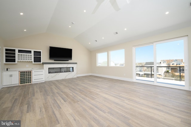1426 Paul Blvd, Manahawkin, NJ 08050 - unfurnished living room with light wood-style floors, vaulted ceiling, a ceiling fan, a high end fireplace, and baseboards