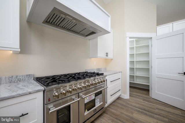 1426 Paul Blvd, Manahawkin, NJ 08050 - kitchen featuring range with two ovens, premium range hood, white cabinetry, wood finished floors, and light stone counters