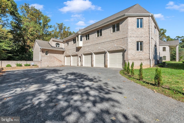 6 Evan Way, Pikesville, MD 21208 - view of front of property featuring brick siding, asphalt driveway, an attached garage, and a front yard
