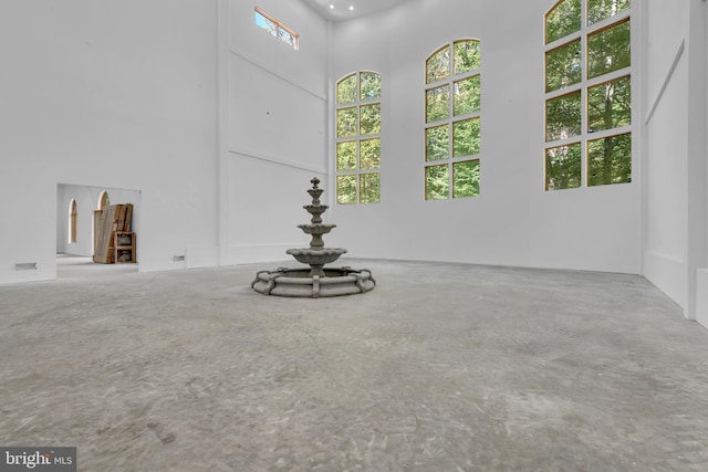 6 Evan Way, Pikesville, MD 21208 - empty room featuring a towering ceiling and concrete floors