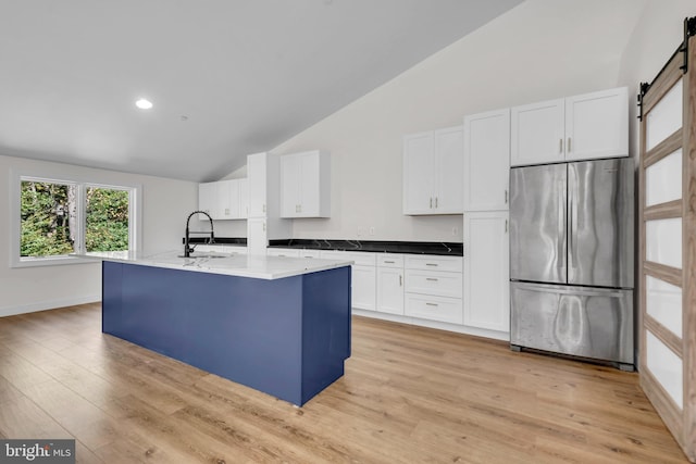 6 Evan Way, Pikesville, MD 21208 - kitchen with freestanding refrigerator, a sink, a barn door, white cabinets, and high vaulted ceiling