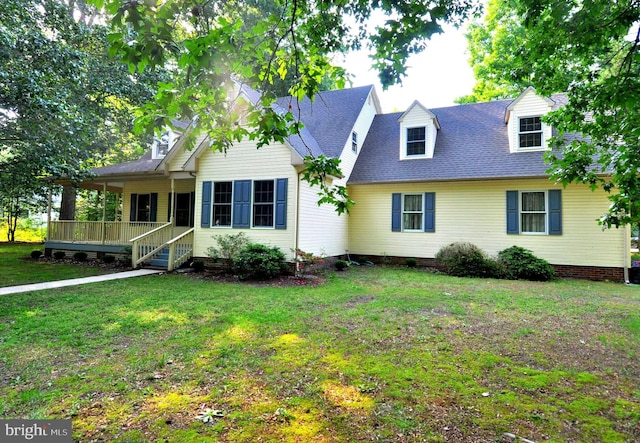 new england style home featuring a front lawn, a deck, and a shingled roof