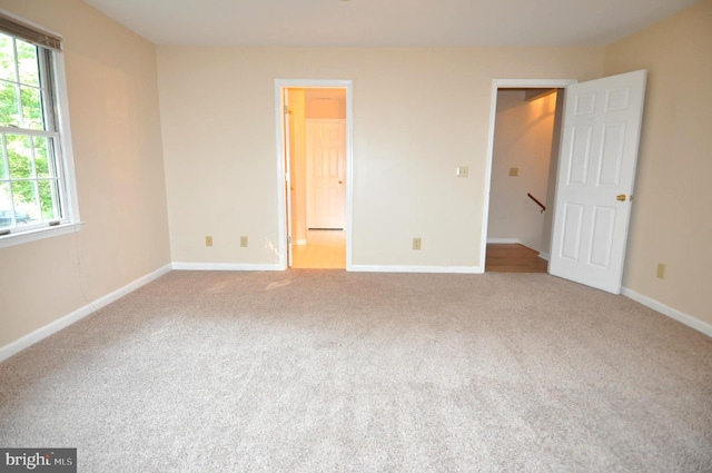 unfurnished bedroom featuring carpet flooring and baseboards