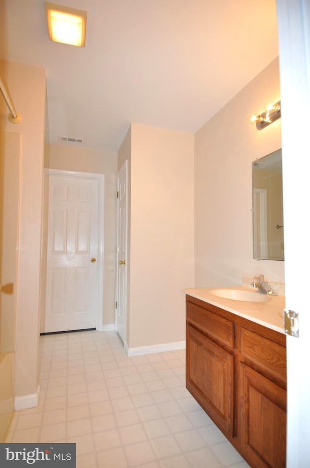 full bath featuring vanity, baseboards, and tile patterned floors