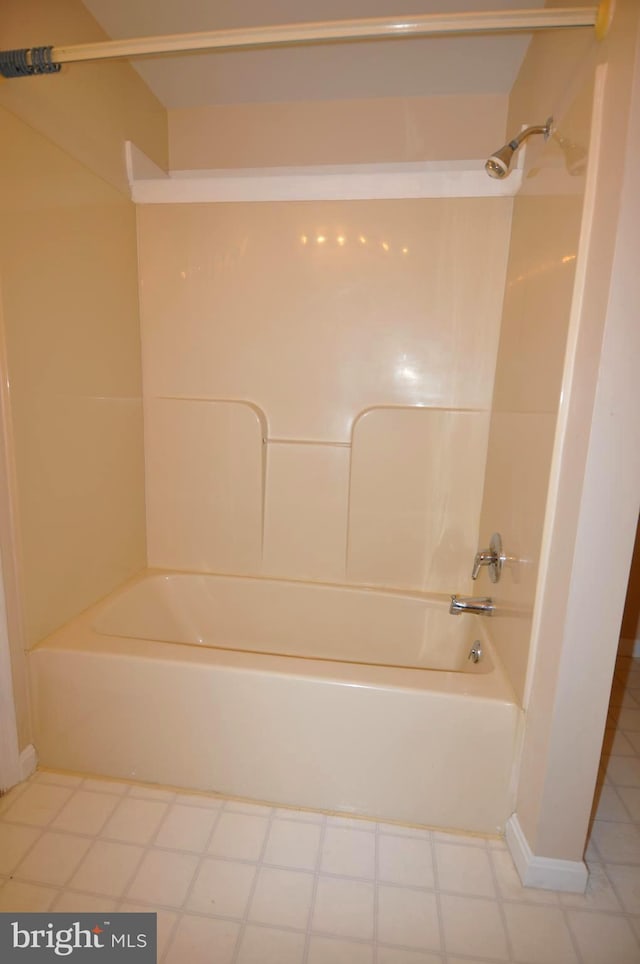 bathroom with washtub / shower combination and tile patterned floors