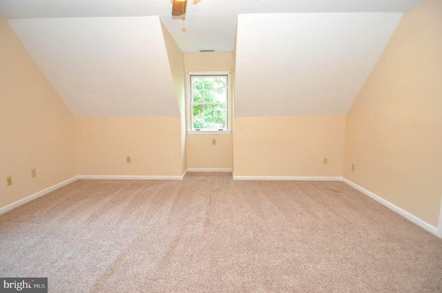 bonus room with light carpet, baseboards, ceiling fan, and vaulted ceiling