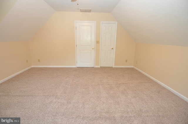 additional living space with lofted ceiling, carpet flooring, and baseboards