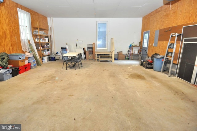 garage featuring wooden walls and electric panel