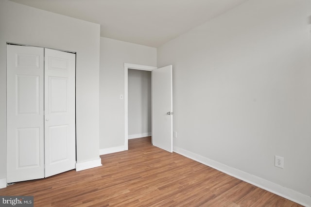 7 18th St SE Unit 208, Washington, DC 20003 - unfurnished bedroom with light wood-style flooring, baseboards, and a closet