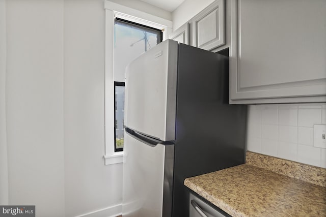 7 18th St SE Unit 208, Washington, DC 20003 - kitchen featuring freestanding refrigerator, backsplash, light countertops, and baseboards