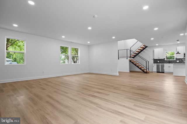 2564 Forrest Ave, Bensalem, PA 19020 - unfurnished living room with recessed lighting, baseboards, light wood-style floors, and stairway
