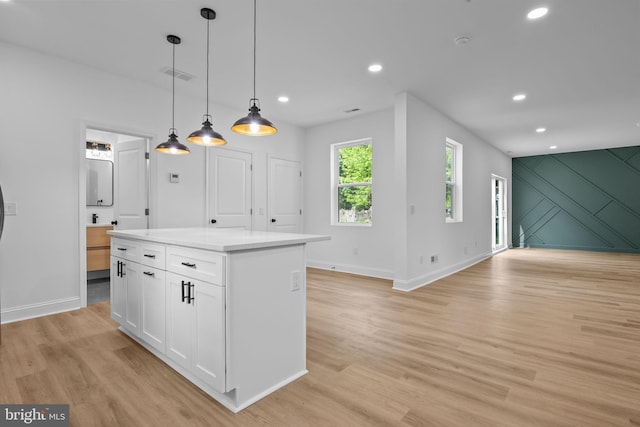 2564 Forrest Ave, Bensalem, PA 19020 - kitchen with white cabinets, light wood-style flooring, a center island, decorative light fixtures, and baseboards