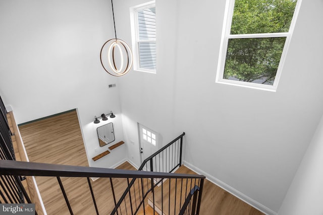 2564 Forrest Ave, Bensalem, PA 19020 - stairs featuring wood finished floors, a high ceiling, and baseboards