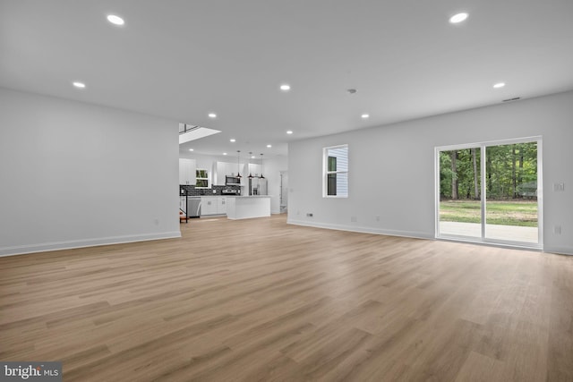 2564 Forrest Ave, Bensalem, PA 19020 - unfurnished living room with recessed lighting, light wood finished floors, and baseboards