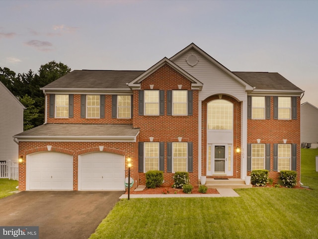 5204 Spanish Dollar Ct, Woodbridge, VA 22193 - view of front of property with asphalt driveway, a garage, a yard, and brick siding