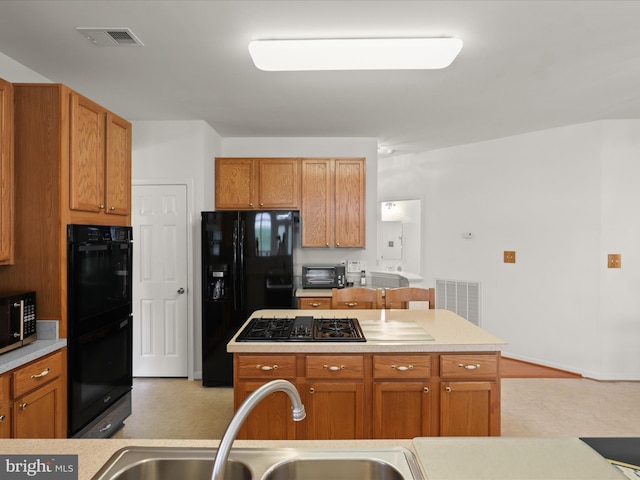 5204 Spanish Dollar Ct, Woodbridge, VA 22193 - kitchen featuring black appliances, a sink, light countertops, and brown cabinetry