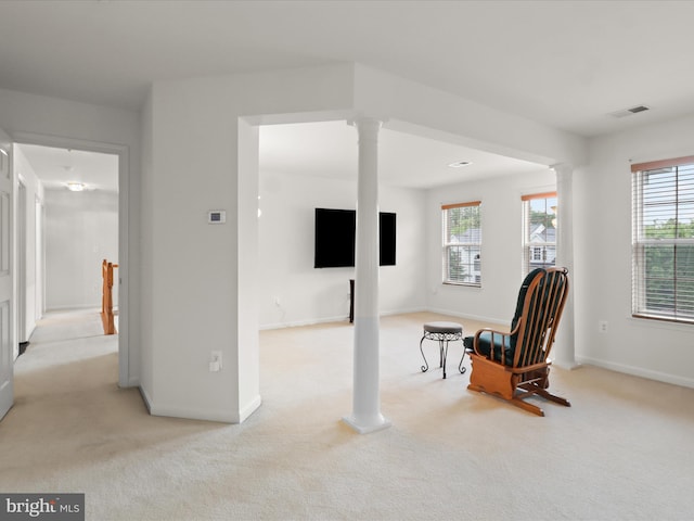5204 Spanish Dollar Ct, Woodbridge, VA 22193 - living area featuring decorative columns, light colored carpet, and baseboards