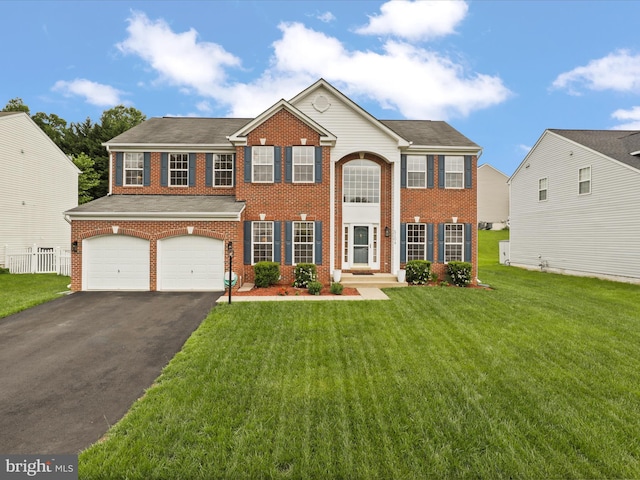 5204 Spanish Dollar Ct, Woodbridge, VA 22193 - colonial house with asphalt driveway, brick siding, a garage, and a front lawn