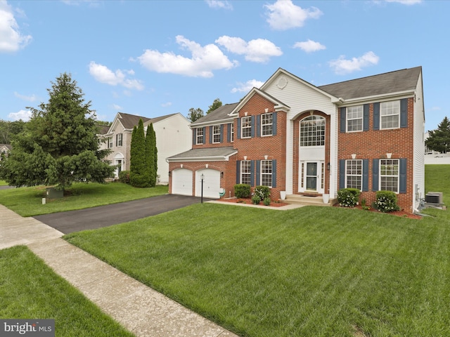 5204 Spanish Dollar Ct, Woodbridge, VA 22193 - view of front facade with central AC, asphalt driveway, brick siding, and a front yard