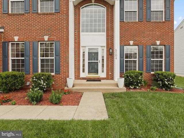 5204 Spanish Dollar Ct, Woodbridge, VA 22193 - doorway to property featuring brick siding and a yard