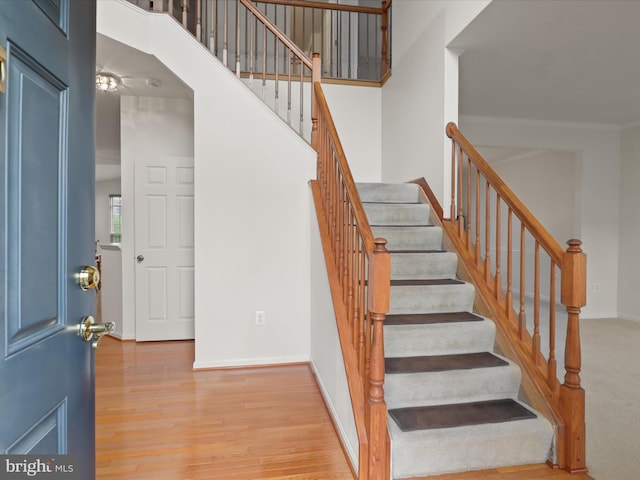 5204 Spanish Dollar Ct, Woodbridge, VA 22193 - stairs with baseboards, wood finished floors, and ornamental molding