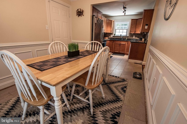 14365 Salsbury Ct, Woodbridge, VA 22193 - dining space featuring a decorative wall, a wainscoted wall, and light tile patterned floors