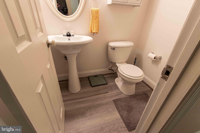14365 Salsbury Ct, Woodbridge, VA 22193 - half bathroom with wood finished floors, toilet, and baseboards