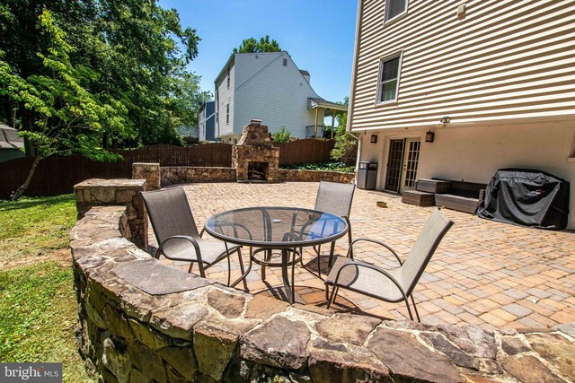 14365 Salsbury Ct, Woodbridge, VA 22193 - view of patio with a fireplace, french doors, and fence
