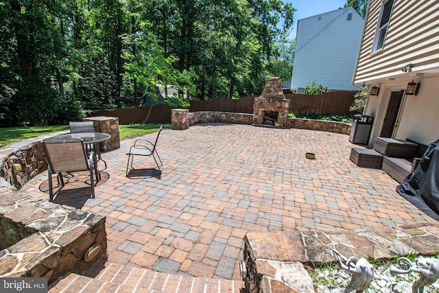 14365 Salsbury Ct, Woodbridge, VA 22193 - view of patio / terrace featuring an outdoor stone fireplace and a fenced backyard