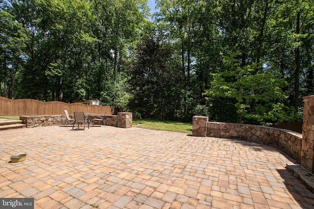 14365 Salsbury Ct, Woodbridge, VA 22193 - view of patio / terrace with fence, outdoor dining space, and view of scattered trees