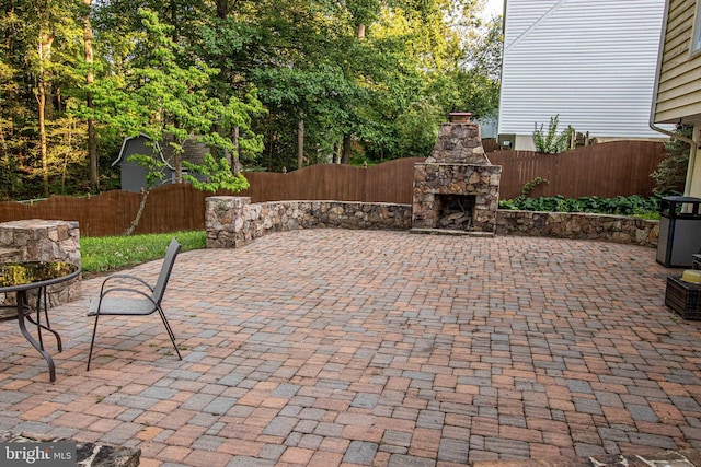 14365 Salsbury Ct, Woodbridge, VA 22193 - view of patio with an outdoor stone fireplace, a fenced backyard, and central AC