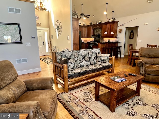 4004 Todd Pass, James Creek, PA 16657 - living area with a ceiling fan, light wood finished floors, a high ceiling, a chandelier, and baseboards