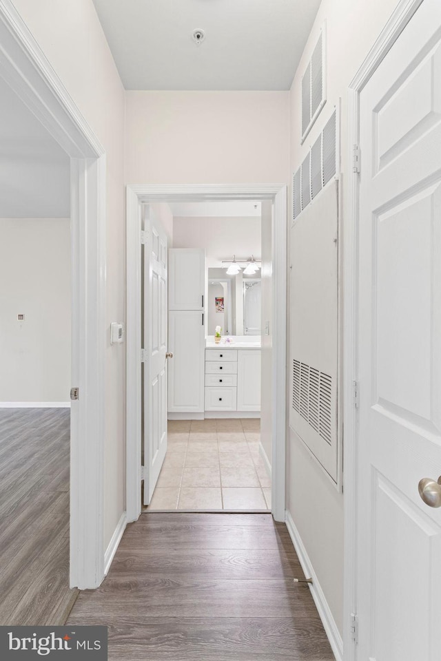 12958 Centre Park Cir Unit 219, Herndon, VA 20171 - corridor featuring a heating unit and light wood finished floors